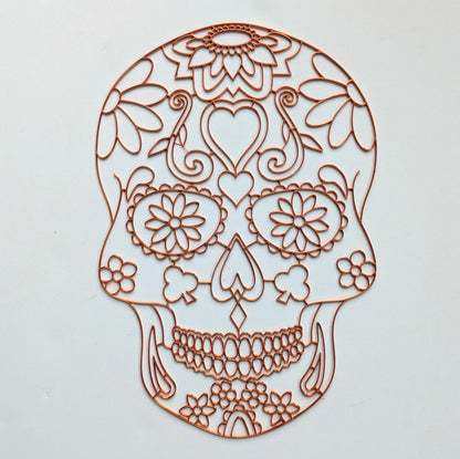 3D printed copper PLA sugar skull resin art template with floral, heart and scroll detail, shown on white background
