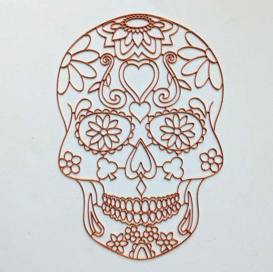3D printed copper PLA sugar skull resin art template with floral, heart and scroll detail, shown on white background