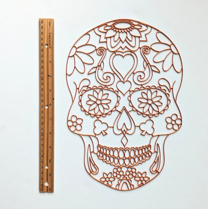 3D printed copper PLA sugar skull resin art template shown next to a 12 inch ruler to indicate size, on white background.